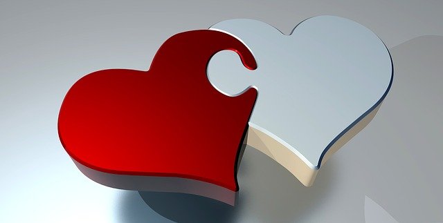 Graphic showing two intersecting hearts joined as if they're part of a jigsaw. The one on the left is red, on the right the heart is silvery grey.