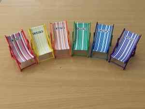 A row of multicoloured deckchairs hiding a message in their stripes