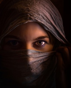 A hooded woman's intense concentration focussing on the eyes