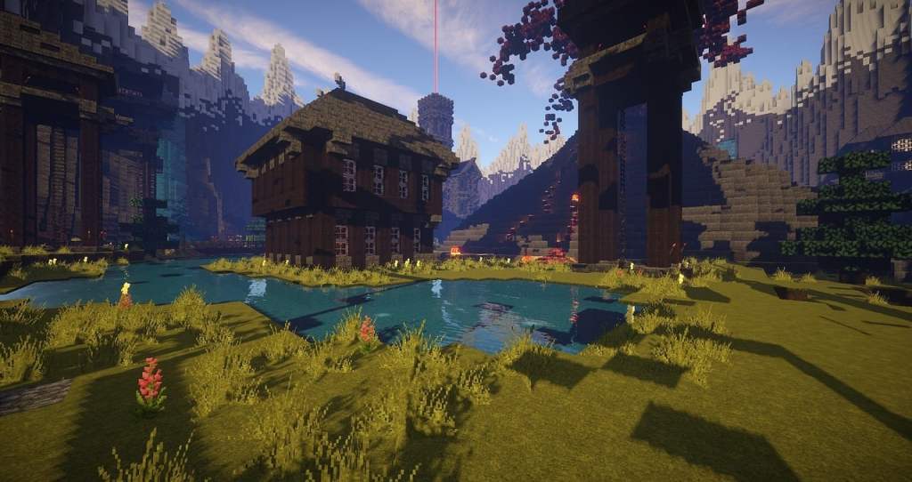 A complex Minecraft world with a lake, grasslands, mountains and a building
